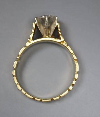 A modern textured 18ct gold and solitaire diamond ring, the stone weighing 0.90ct, size L, gross 4.1 grams,